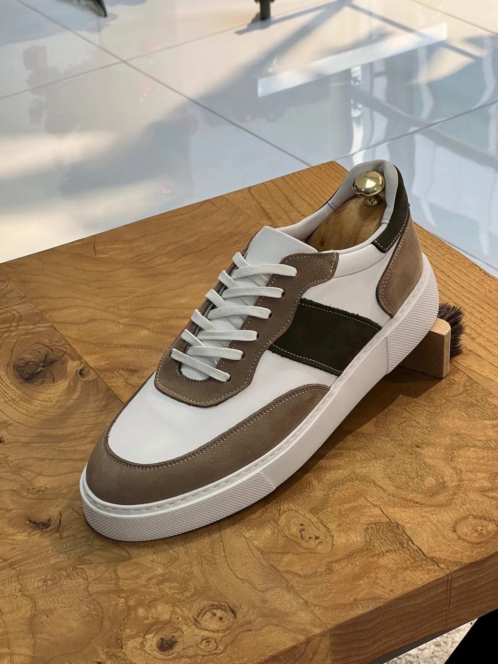 Stylish beige suede loafers with gold bit accents, perfect for classy and sophisticated occasions.